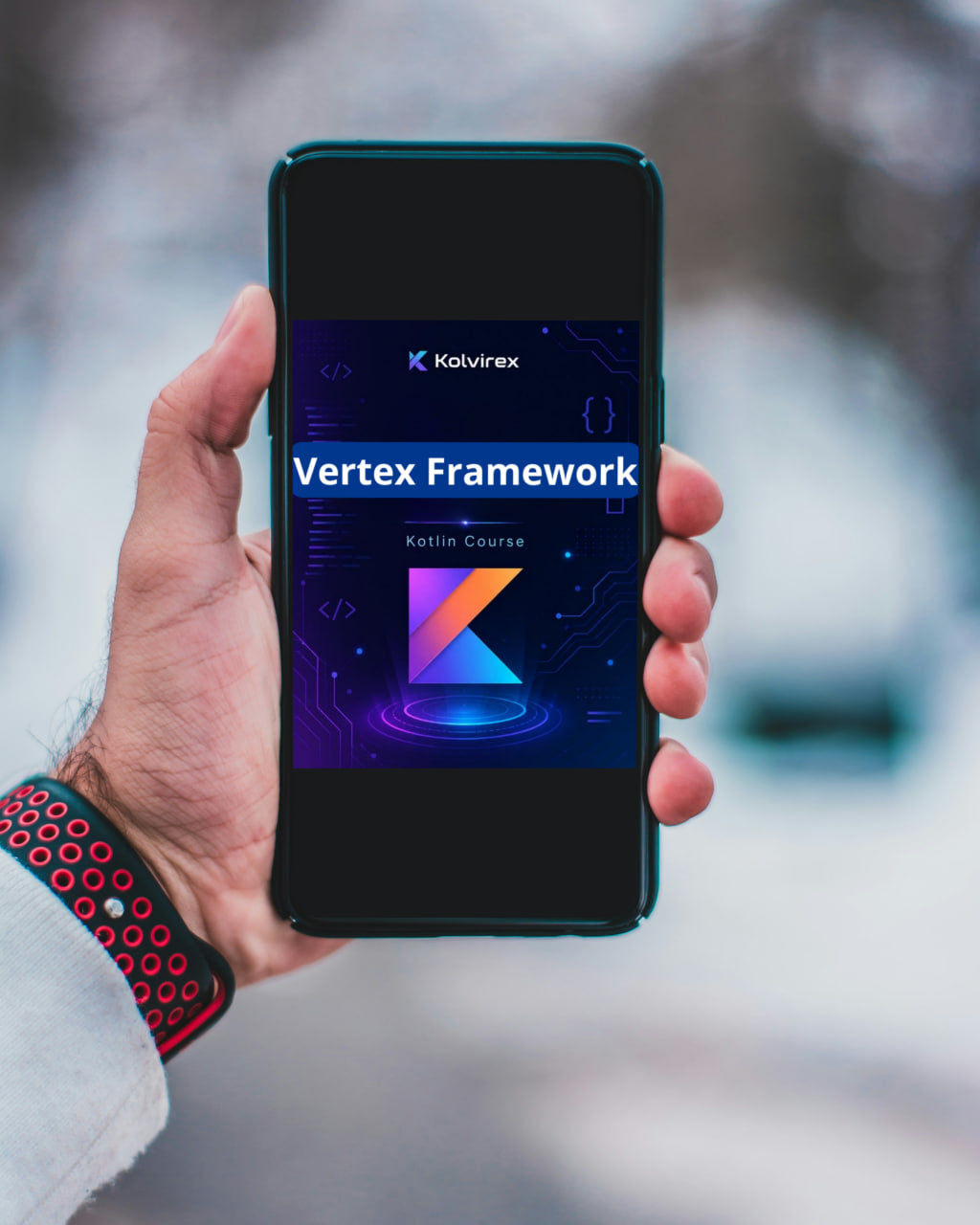Hand holding a smartphone displaying the Kolivrex Vertex Framework app with a blurred outdoor background.